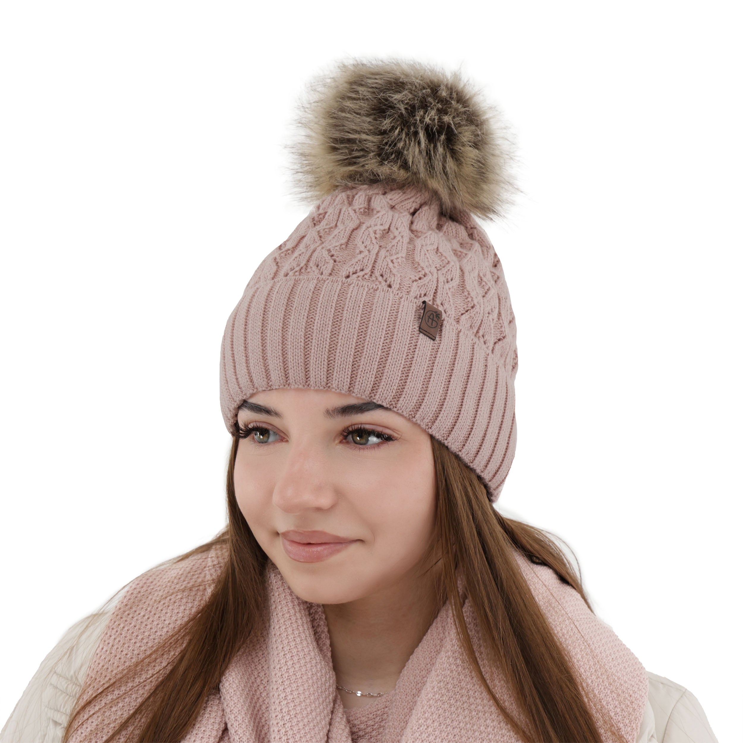 Caciula de dama roz din lana merinos, tricotata cu model impletit si pompon moale din blana sintetica.
